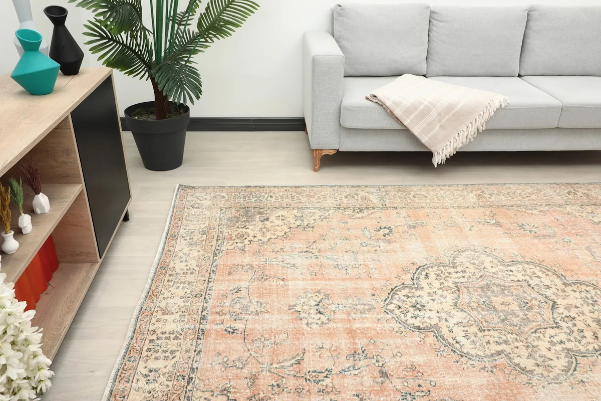 Perspective view of the tan area rug from the side, complementing the room's decor