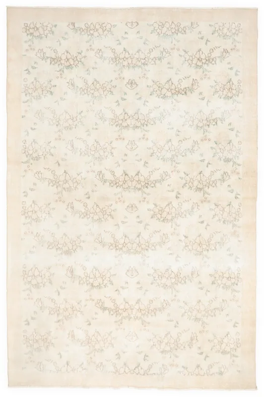 Full overhead view of the 6'9" x 10'3" ivory vintage Anatolian wool rug with subtle floral patterns