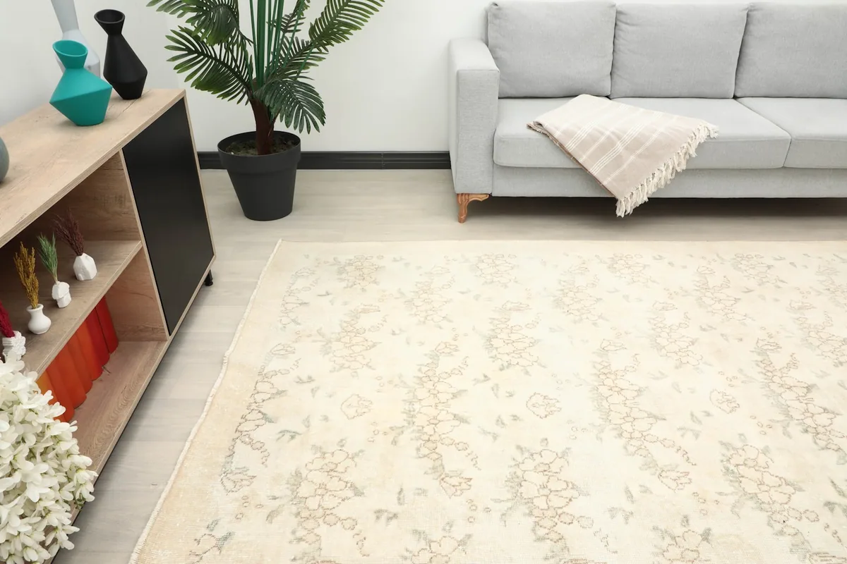 Angle view of the large ivory rug in a modern living space with a gray sofa