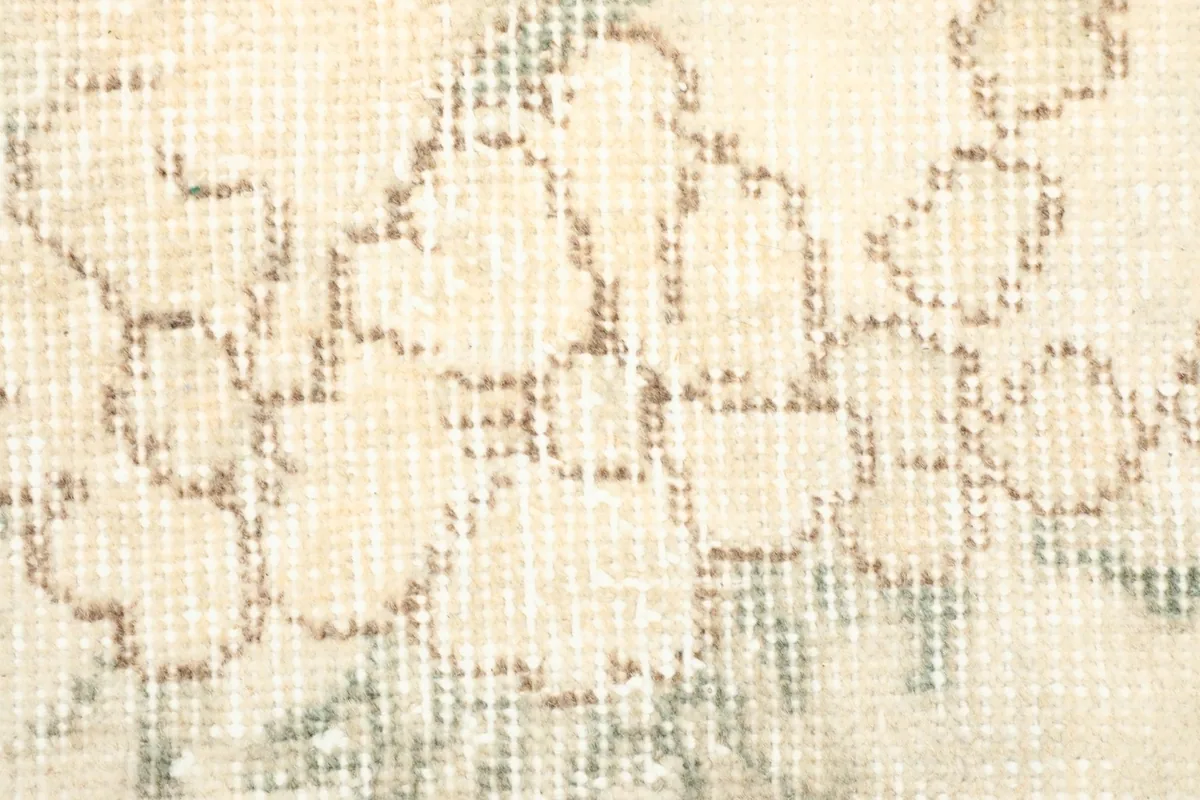 Texture detail showing the low wool pile and the hand-knotted construction of the rug