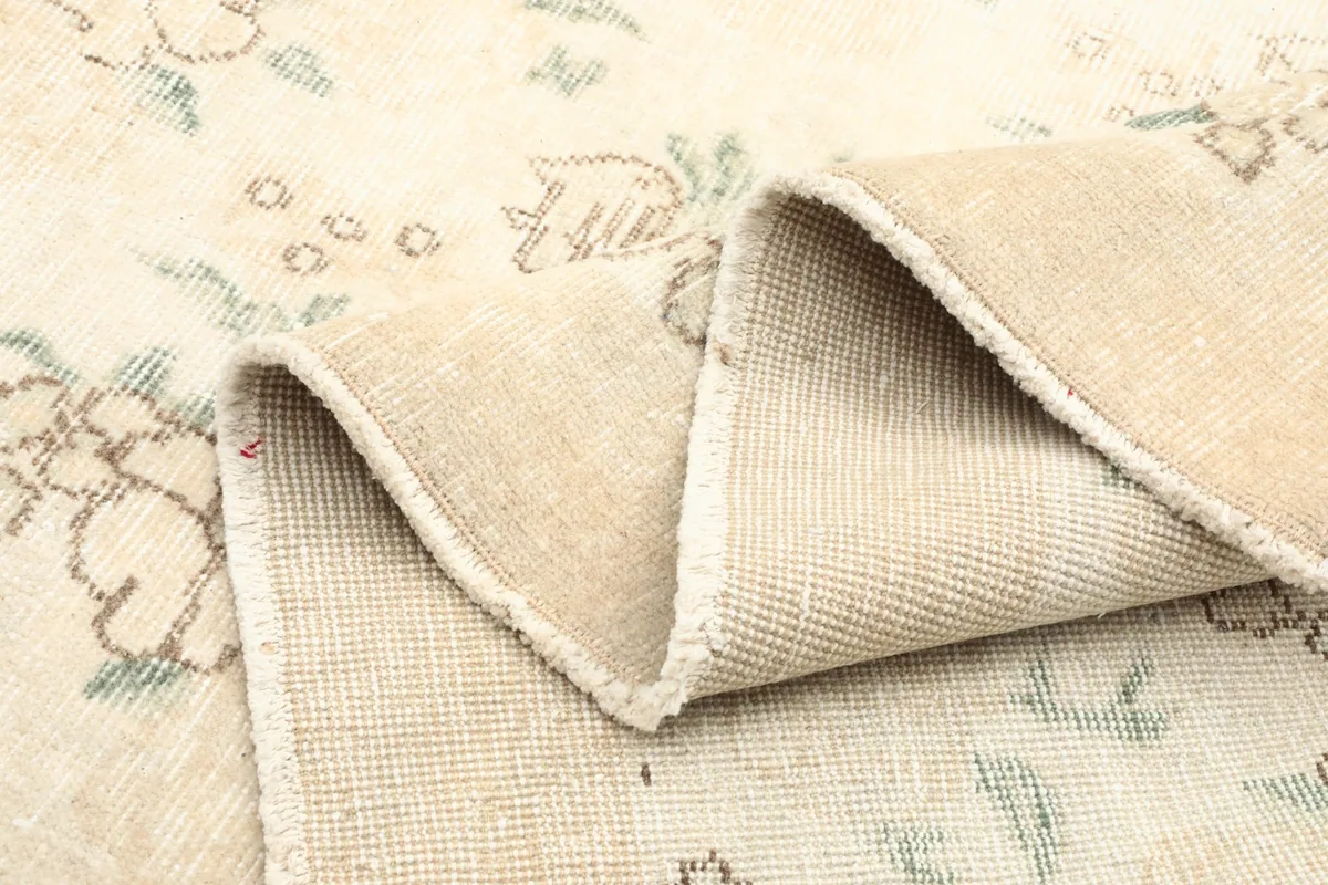 Folded section of the rug, revealing its thickness and the quality of the wool pile