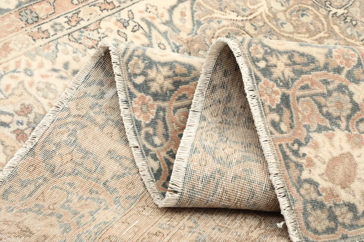 Close-up of the low wool pile, showing the texture and colors of the vintage rug
