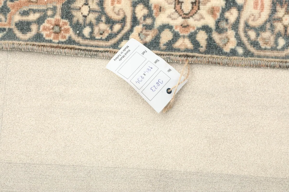 Tag showing the rug's size and identification details on a light background