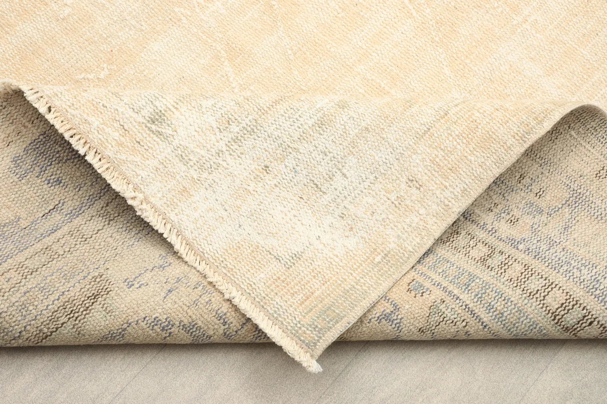 Corner folded back to show the cotton foundation and hand-knotted construction of the Anatolian rug.