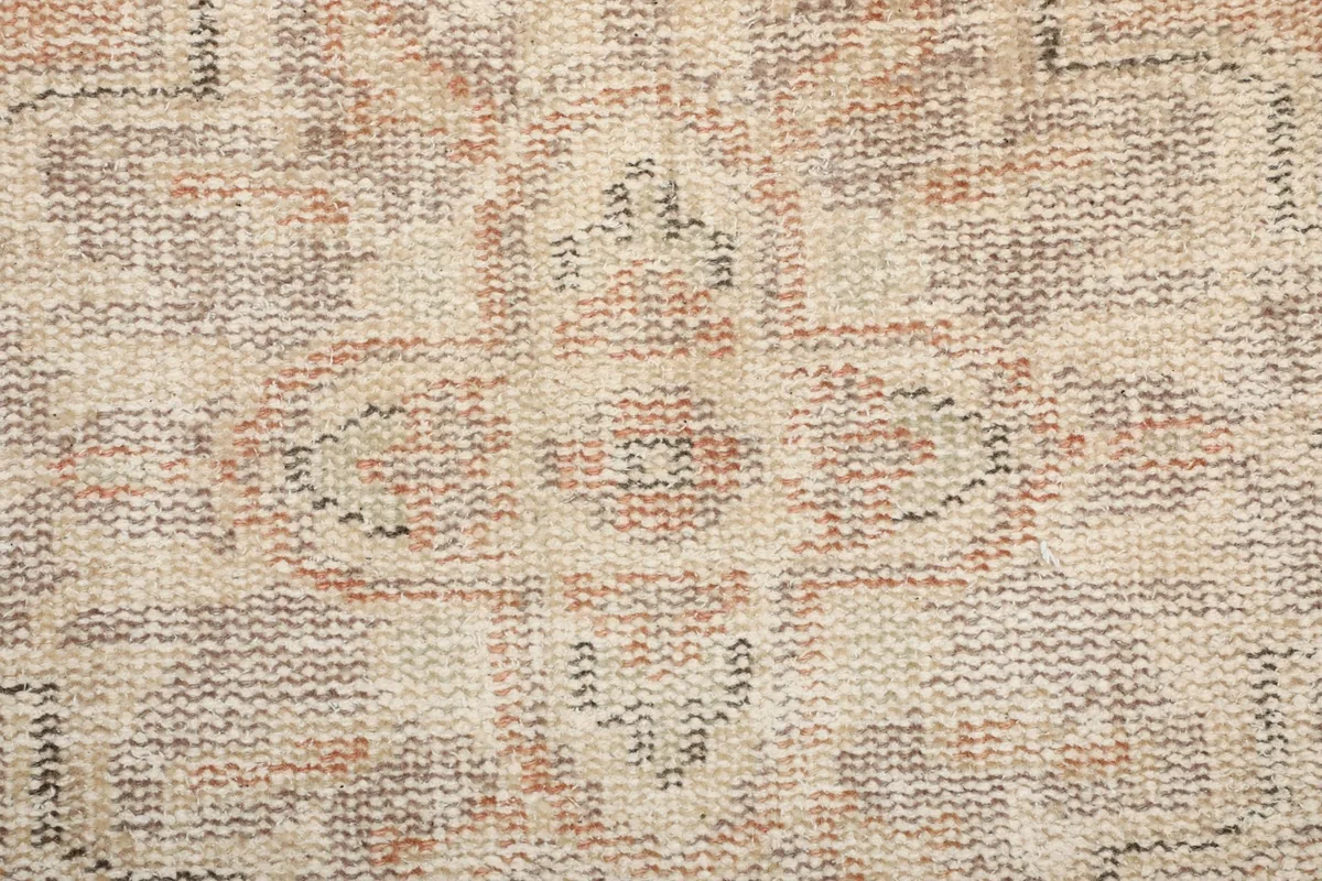 Extreme close-up of the low wool pile, showing individual knots and color variations.