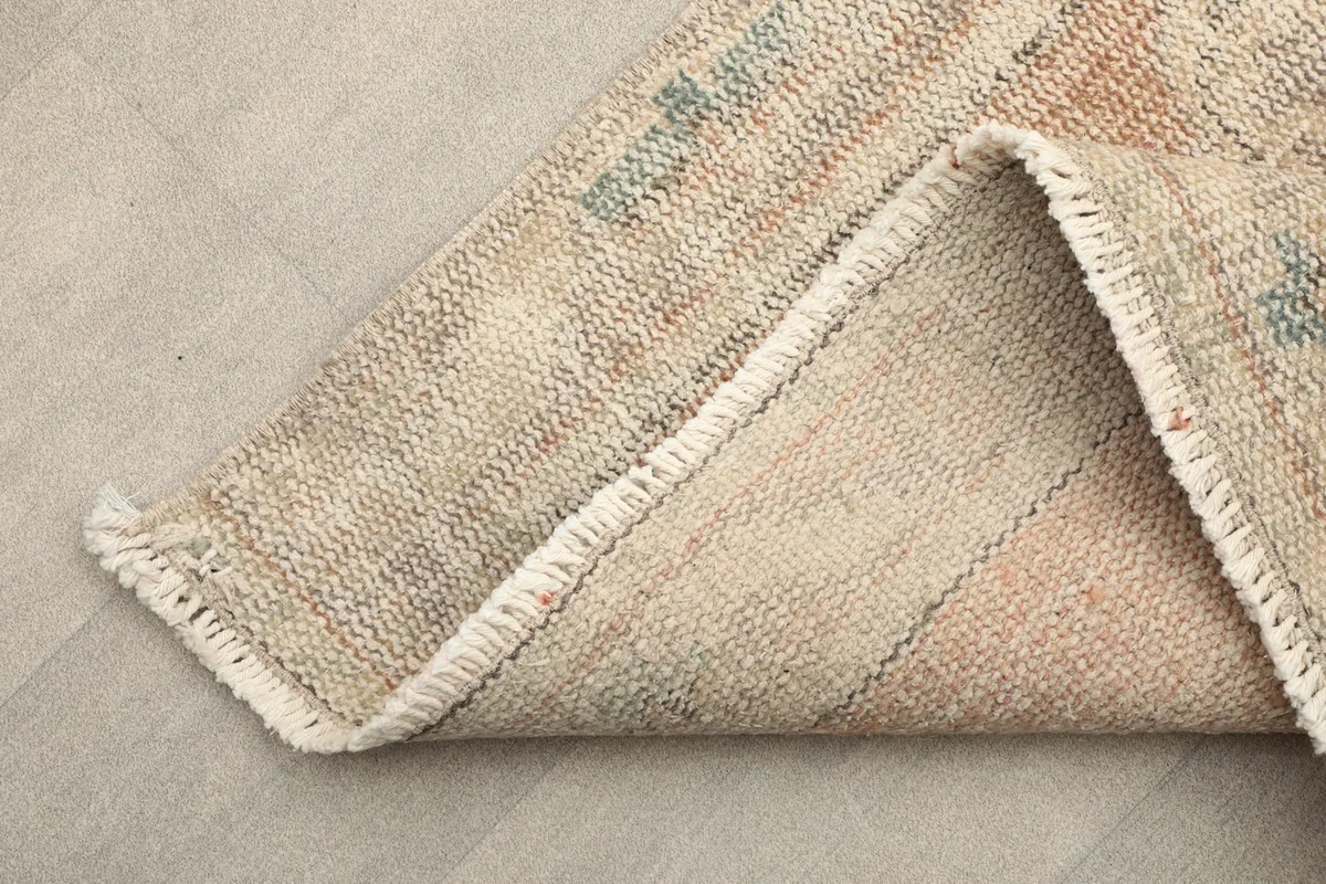 Corner view showing the hand-knotted cotton foundation and reverse side of the runner rug.