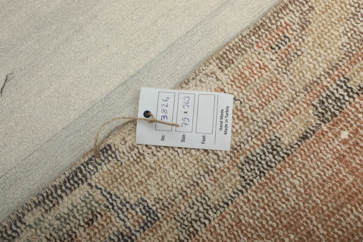 Tag attached to the back of the rug, showing details like size and origin.