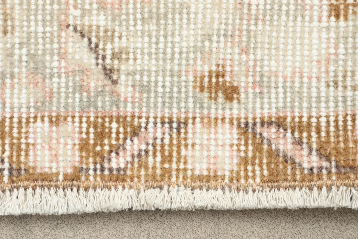 Close-up of the low wool pile and fringe of the vintage Anatolian rug