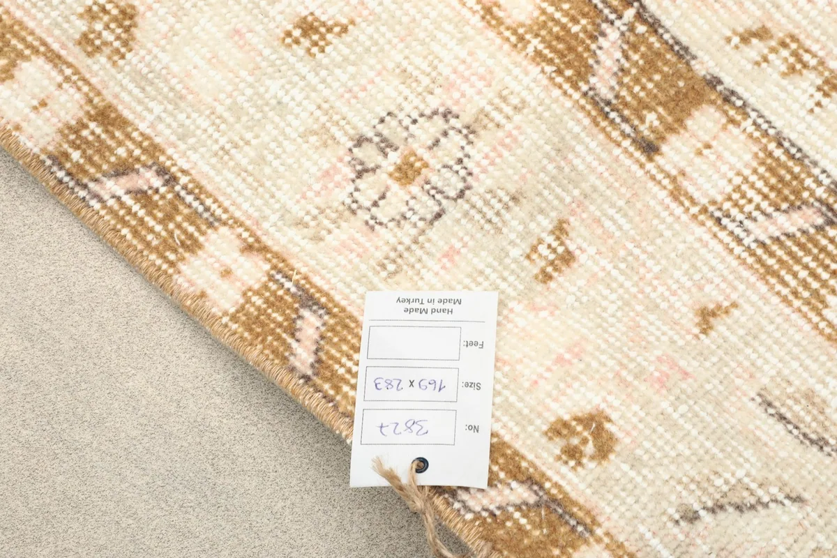 Product tag displaying the rug's dimensions and origin, placed on the rug