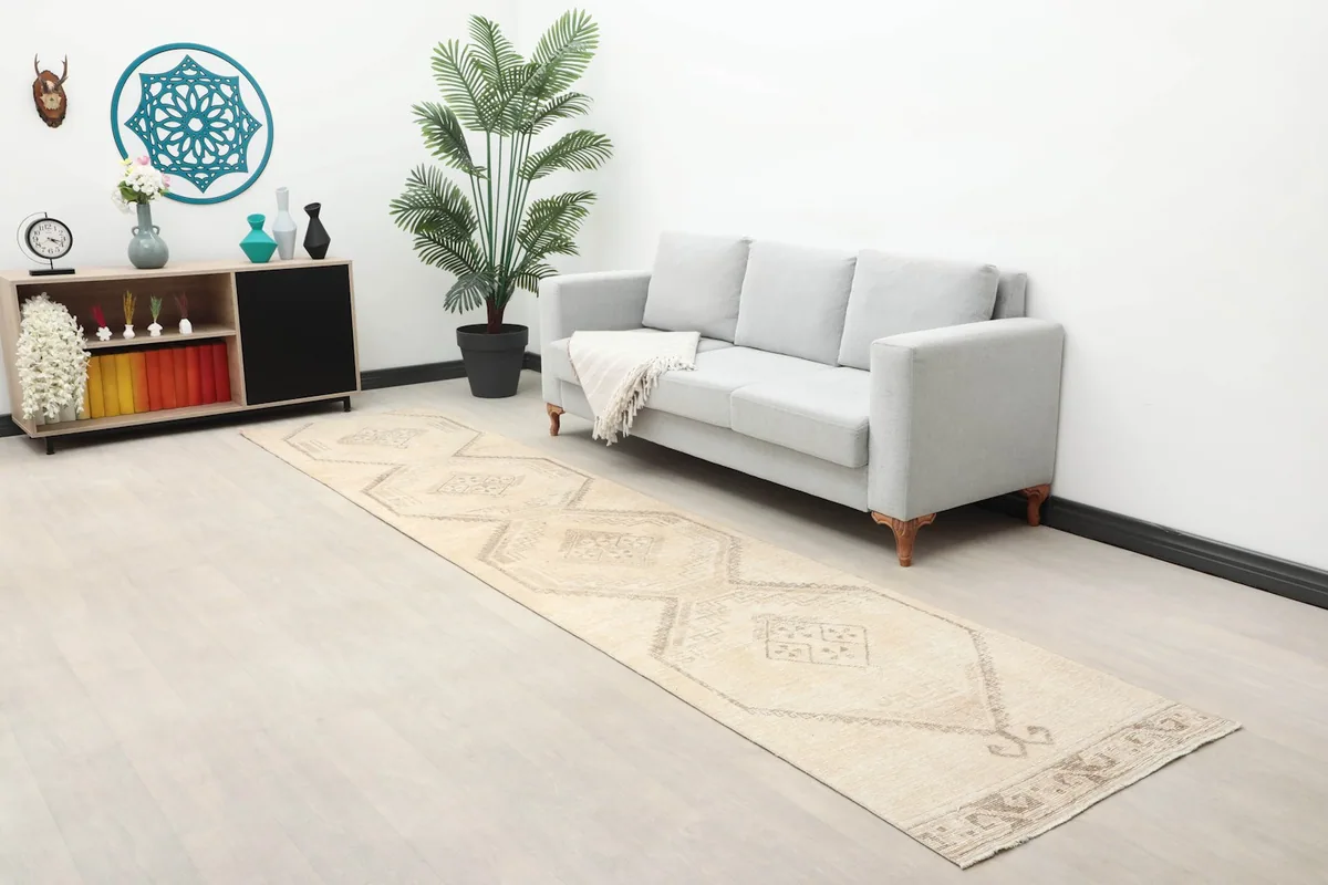 Long shot of the ivory and gray runner in a living space with a couch and console table.