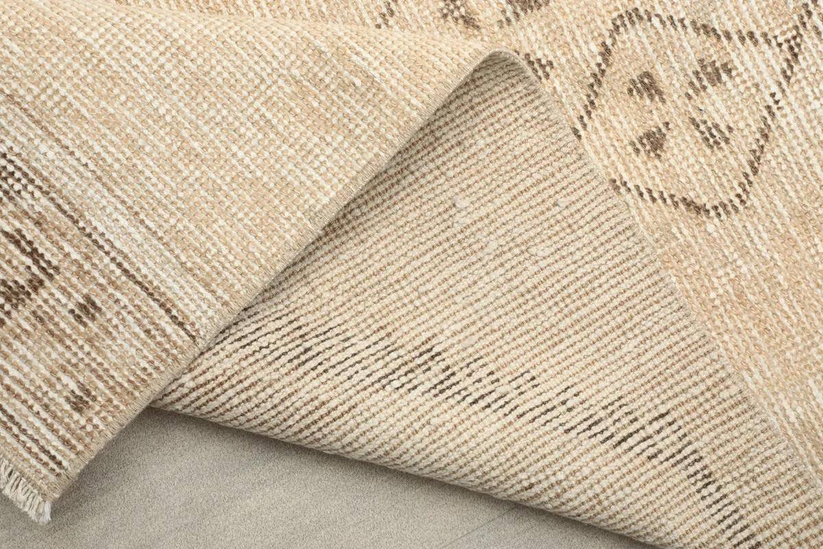 View of the rug's underside, indicating its hand-knotted construction.