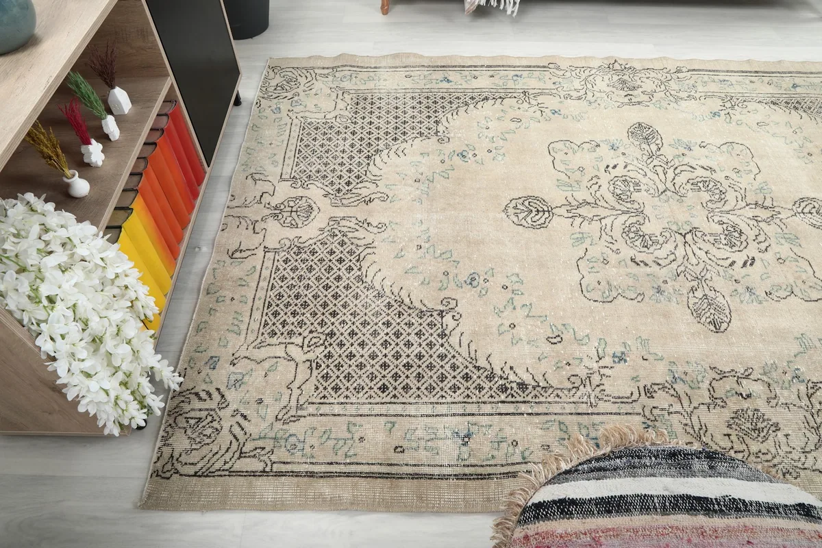 Wide shot of the vintage rug in a room, showing its scale relative to furniture