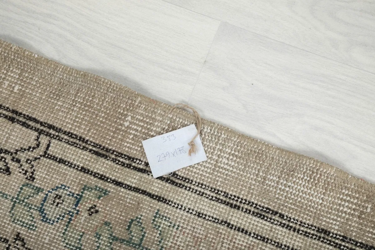 Detail of the rug's edge and the woven cotton foundation, with a product tag