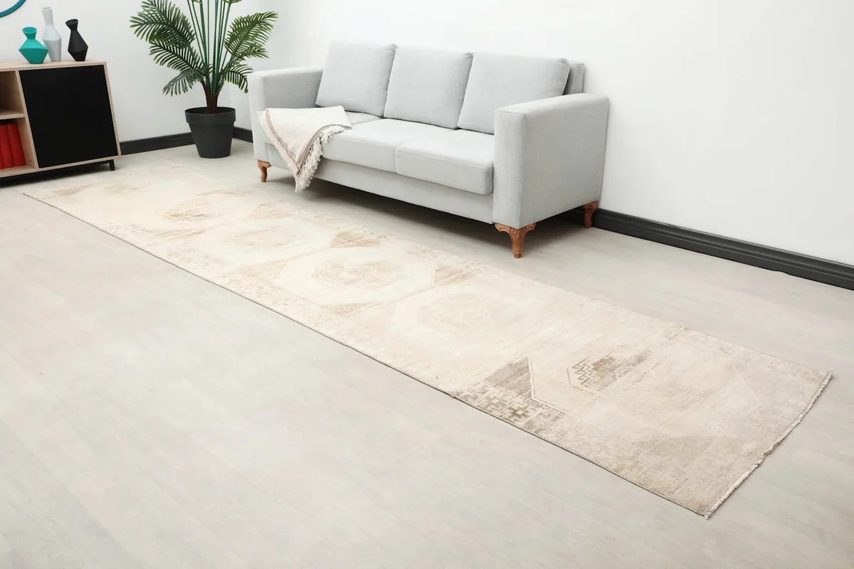 Overhead view of the beige runner rug laid out in a modern living space.