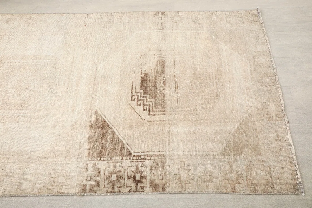 Close-up of a section of the runner rug, highlighting the geometric medallion and border patterns.