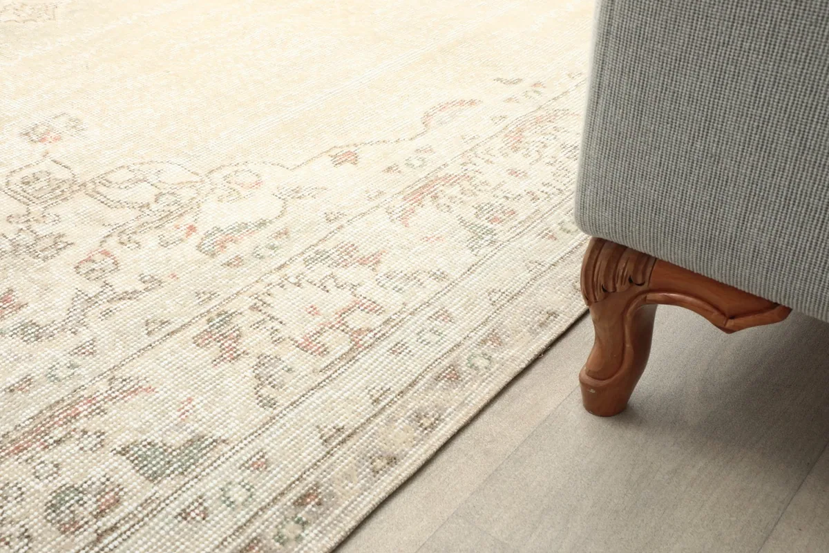 Rug placed next to a sofa leg, showcasing how it fits into a home environment