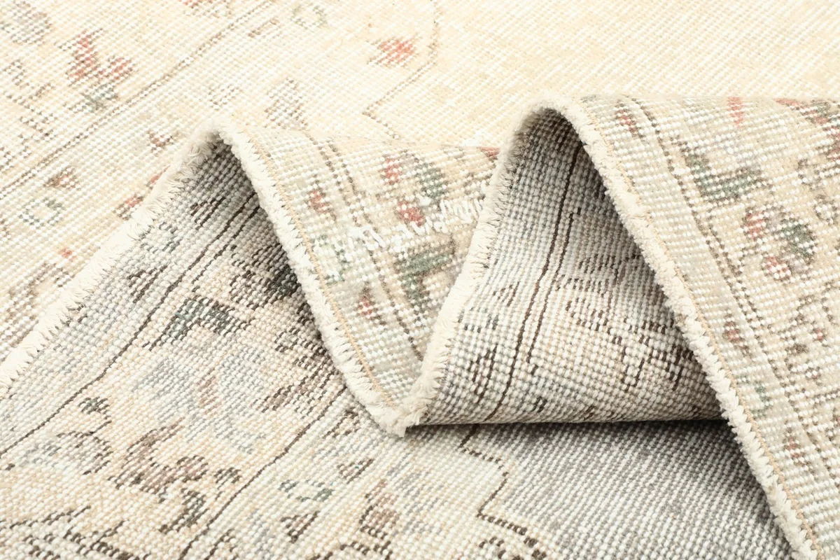 Detailed view of the rug's flexibility and the back of the hand-knotted construction