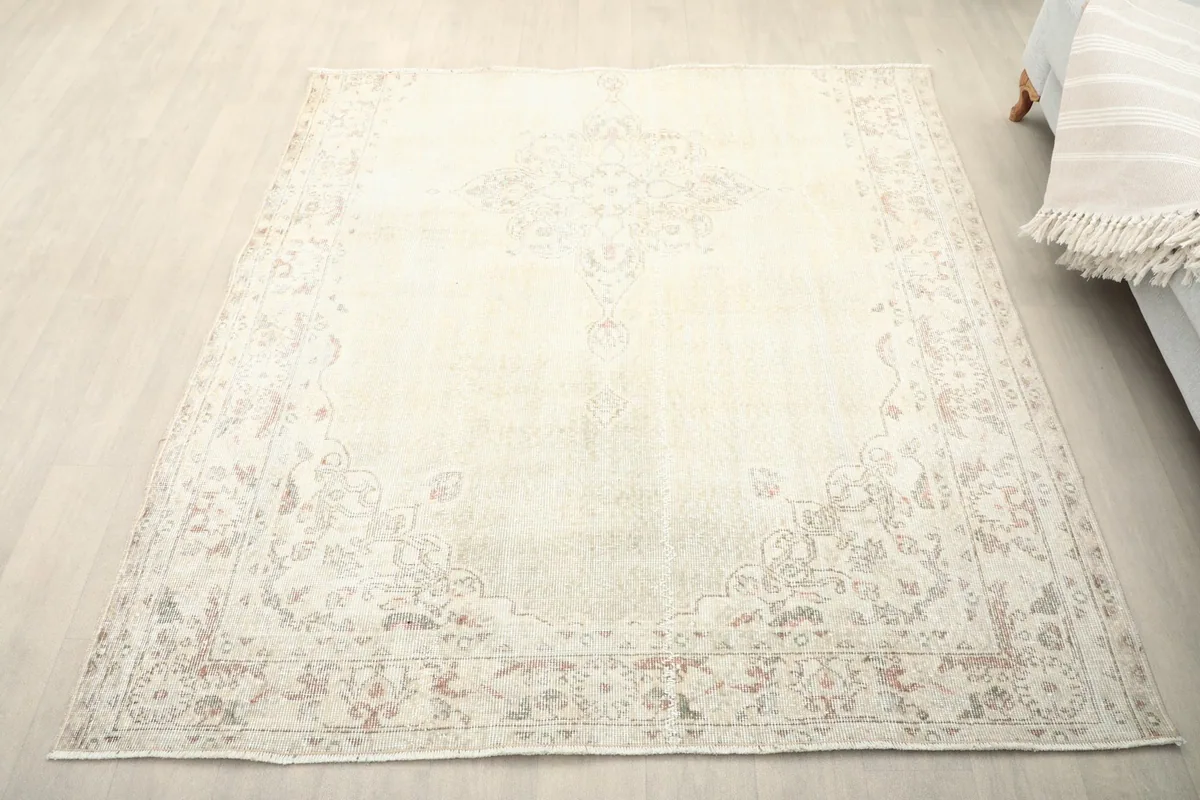 Overhead view of the ivory rose rug showing its placement on a light floor