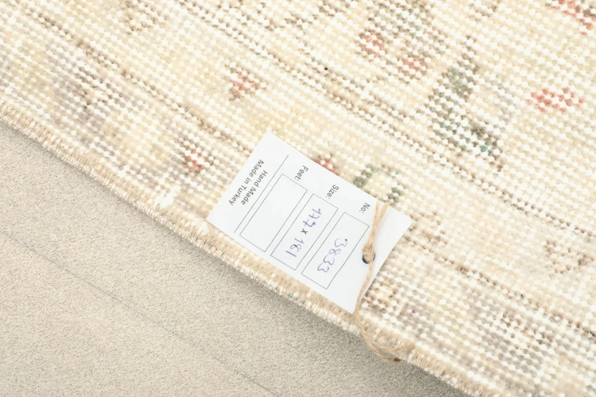 Tag showing the rug's dimensions of 177 x 181 cm, confirming its origin and material