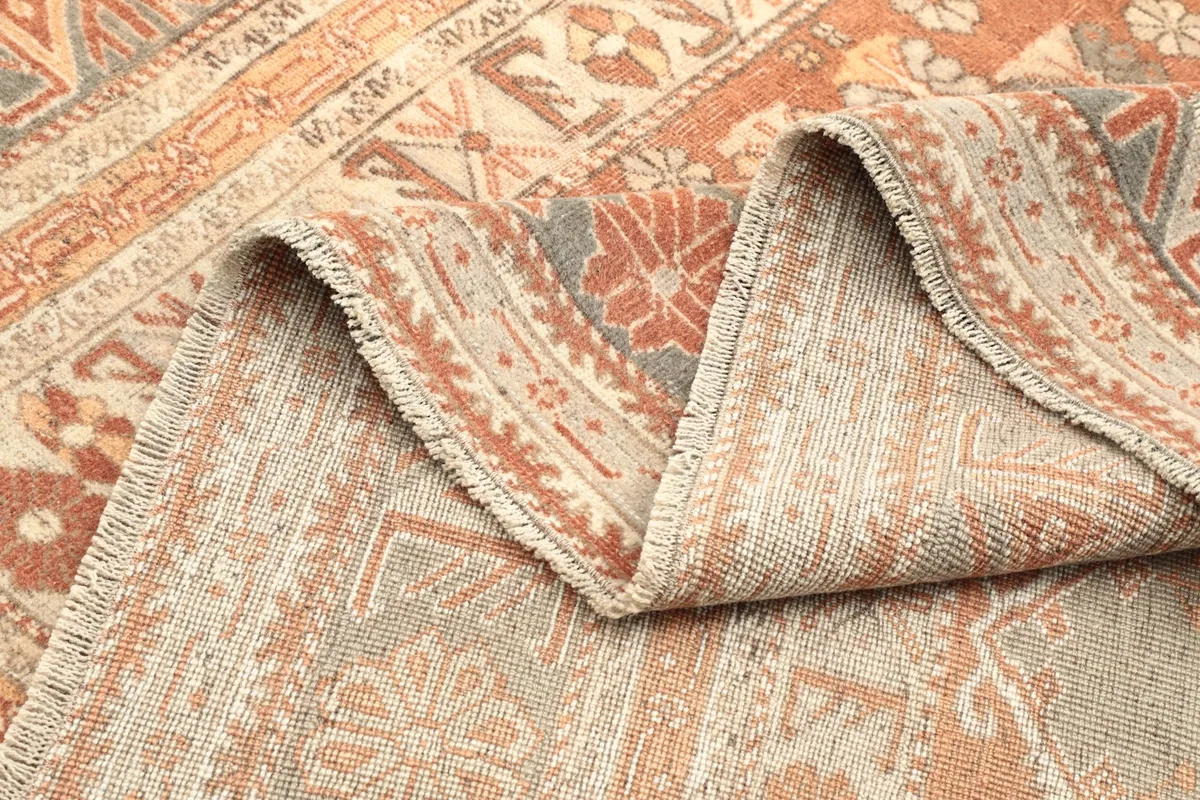 Folded section of the rug showing the wool pile and cotton foundation