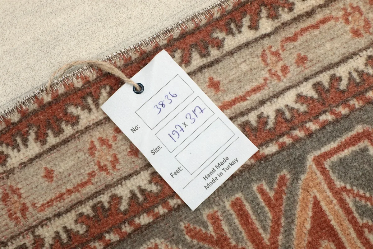 Product tag showing the rug's dimensions and 'Hand Made in Turkey'