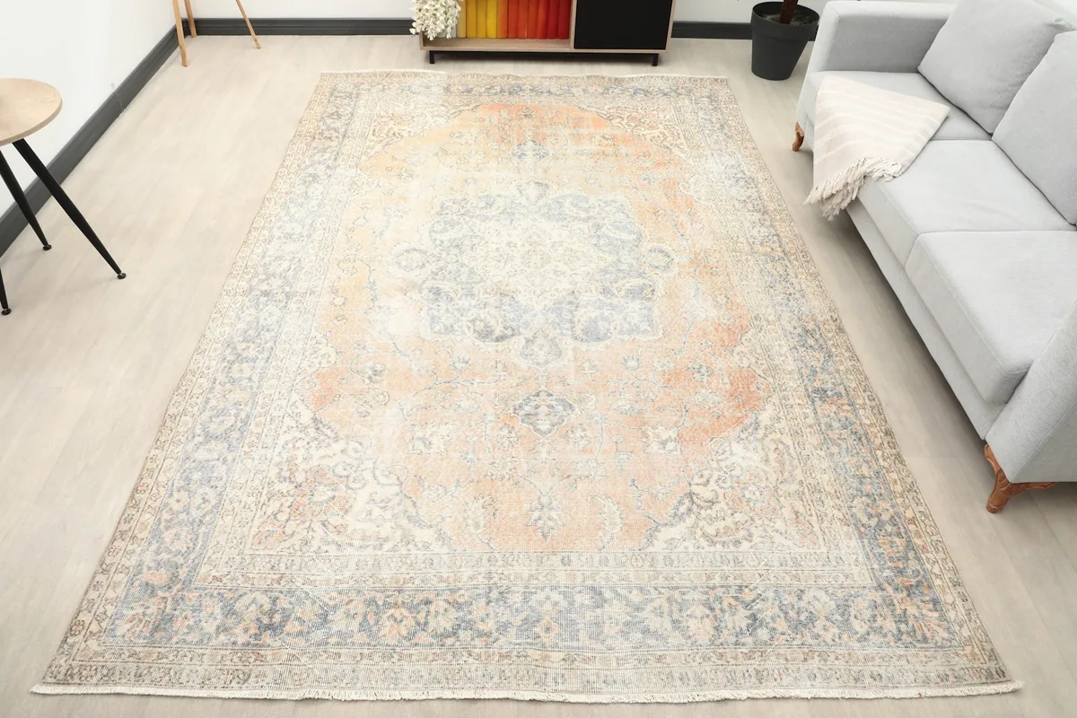 Vintage orange and blue area rug placed in a modern living room setting