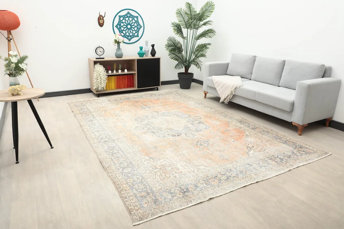 Angle view of the large orange and blue rug complementing a living room space