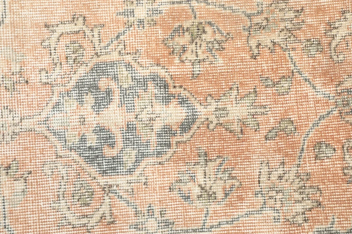 Detail of the orange field showing faded floral patterns and texture