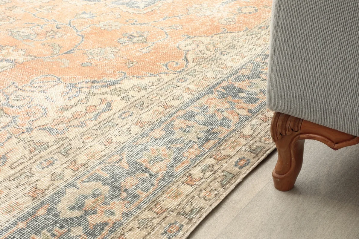 Close-up of the low pile texture and colors next to a sofa leg