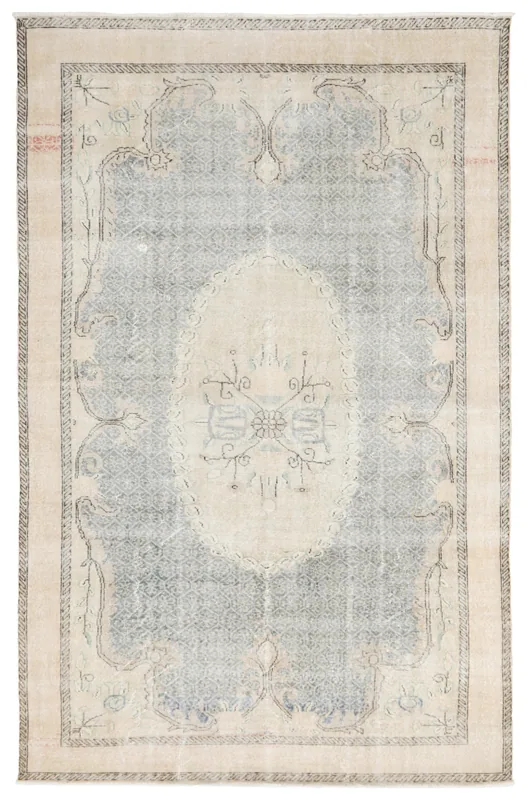 Full overhead view of the beige and blue vintage Anatolian area rug