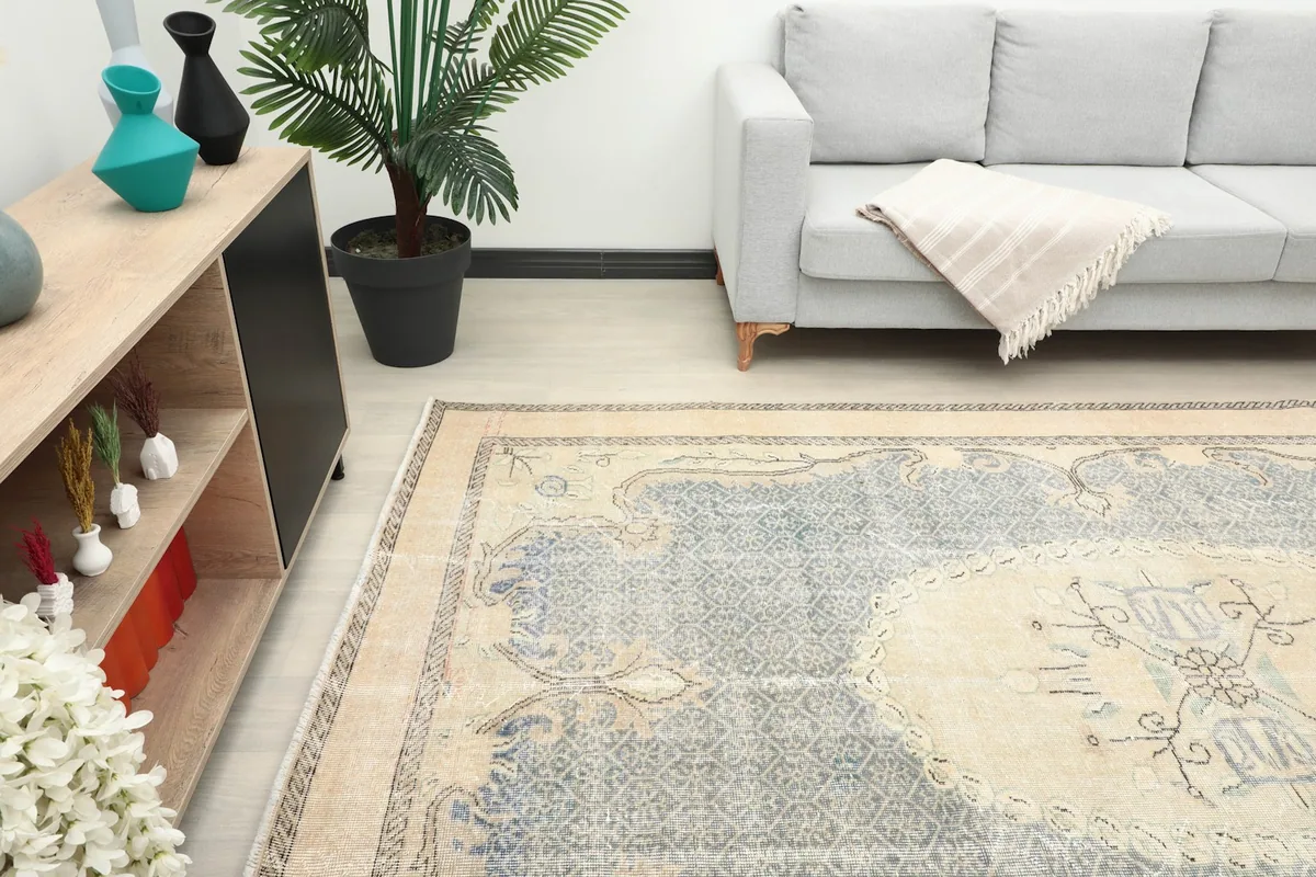 Partially visible vintage rug in a room, showing its scale next to furniture