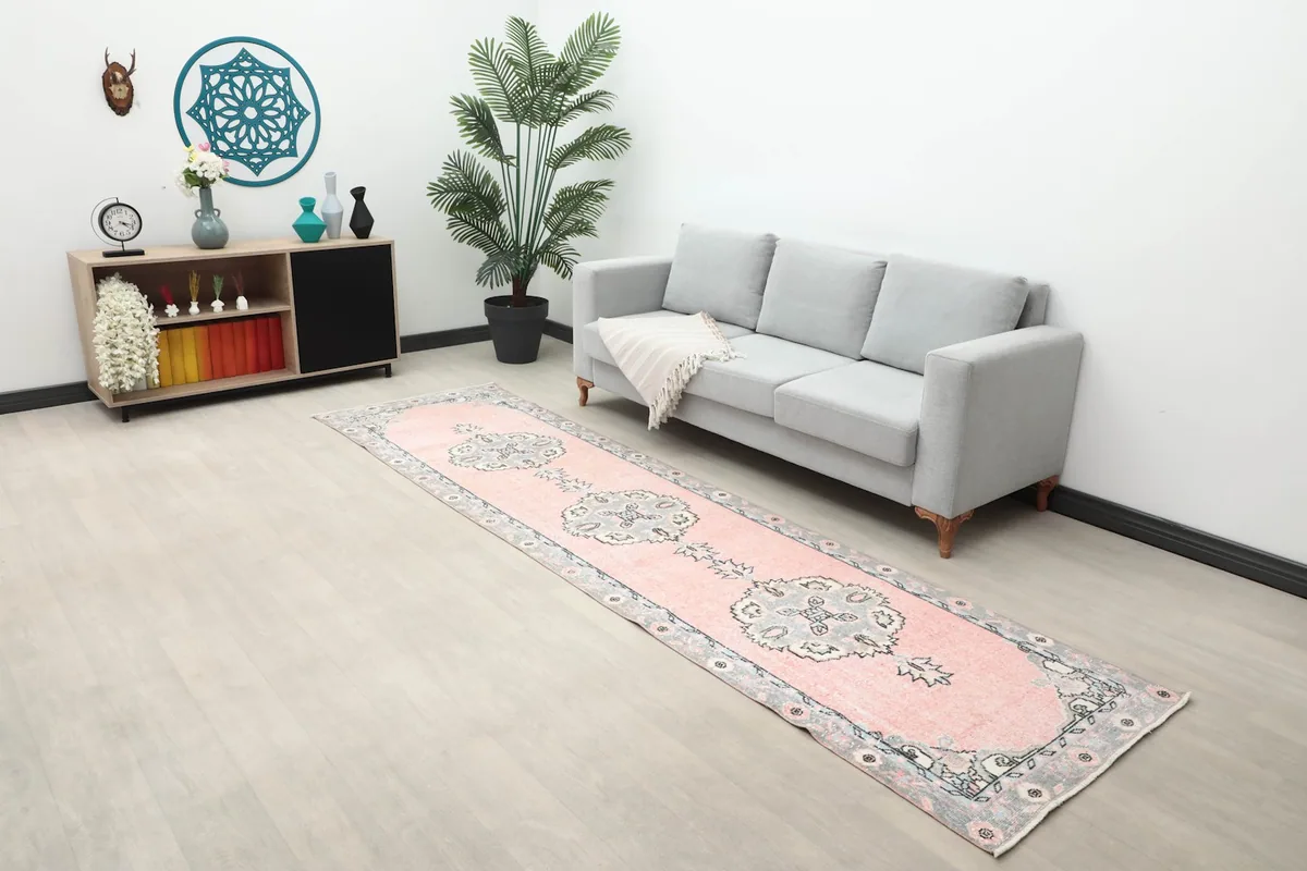Wide shot of the runner rug in a room with a sofa, side table, and wall decor, highlighting its placement.