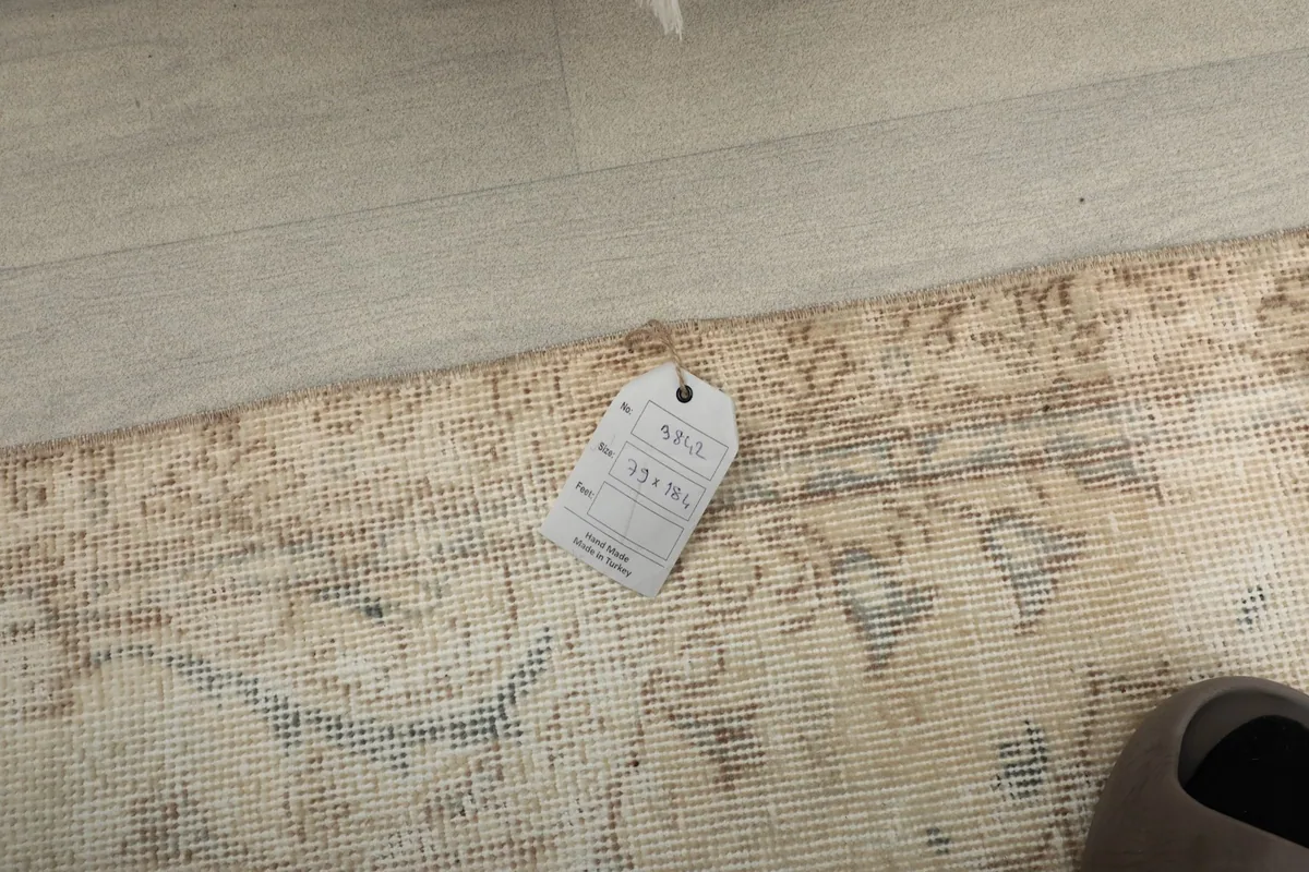 Close-up of the rug's corner with the product tag, showing its size and details.