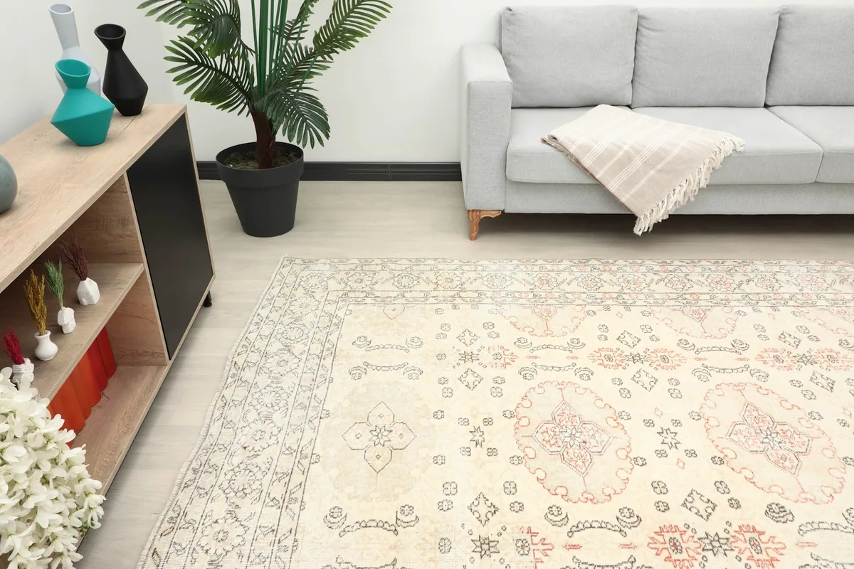 View of the rug extending into a room, showing its large size and soft color palette