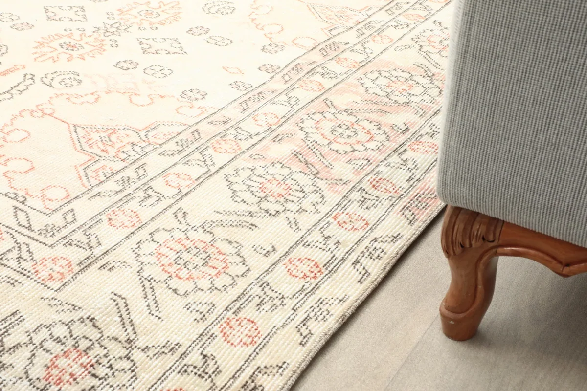Rug placed next to a sofa leg, showing its integration into a home decor setting