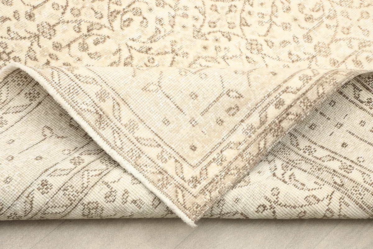 Folded corner of the Subtle Beige Floral Anatolian Rug, revealing the hand-knotted construction.