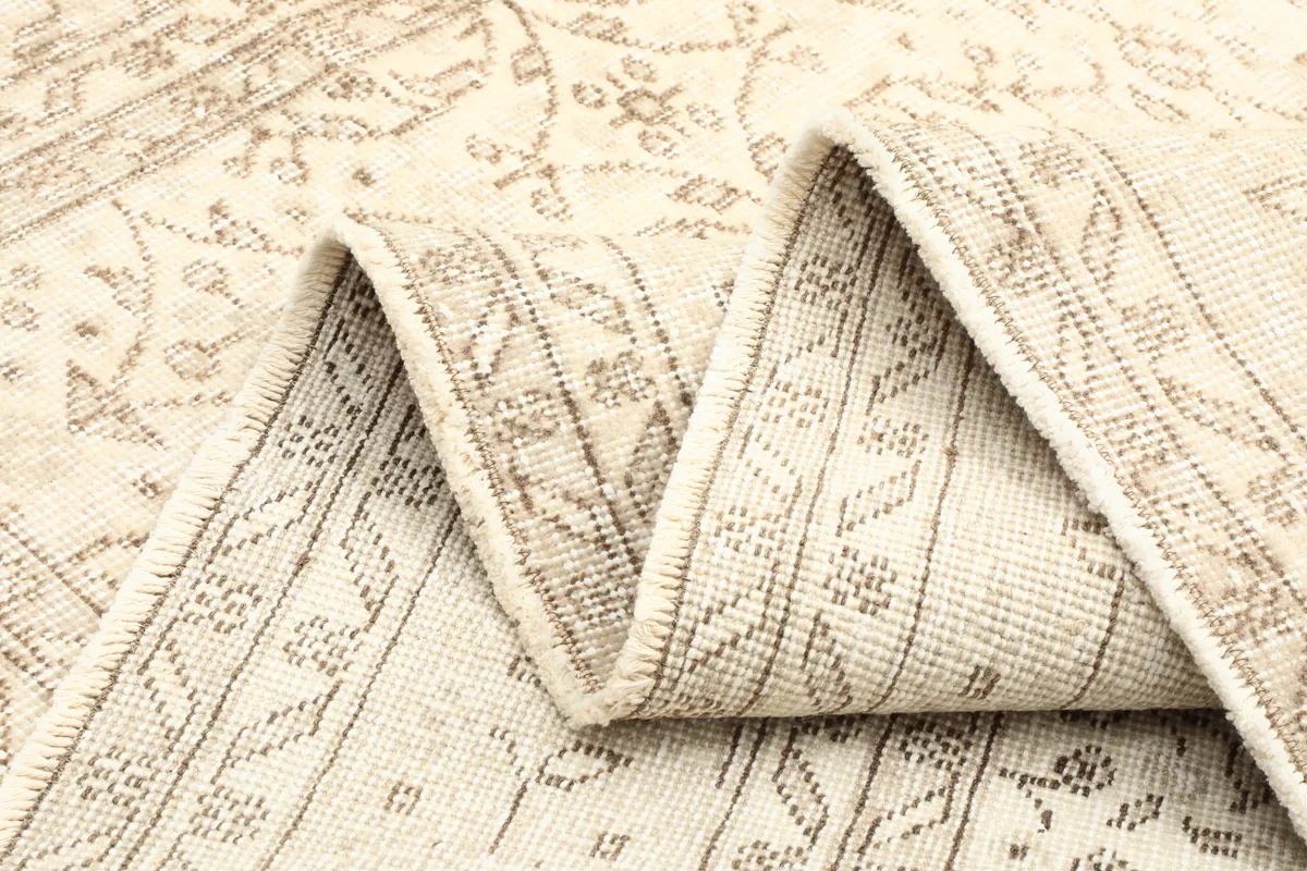 Reverse side detail of the Subtle Beige Floral Anatolian Rug, showing the cotton foundation and knotting.