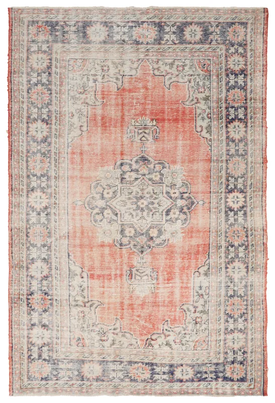 Full top view of the vintage Anatolian rug with a rust field and navy border on a white background