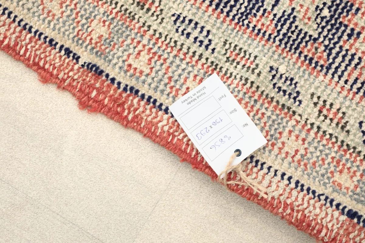 Close-up of the rug's edge with a product tag, showing the weave and fringe