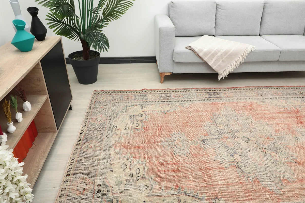 View of the rug from a lower angle in a room, showing its placement relative to a sofa