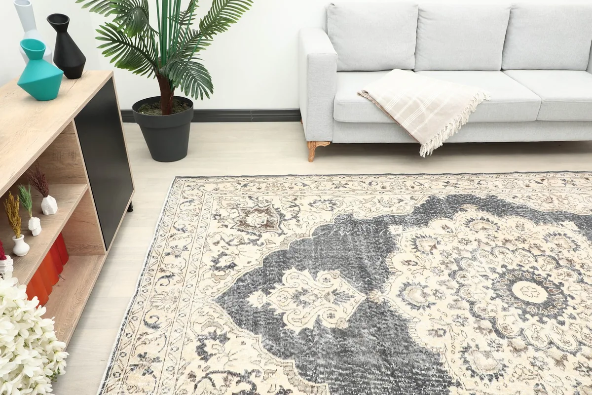 Section of the rug in a living room, highlighting the central charcoal medallion
