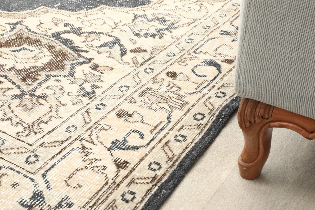 Rug edge next to furniture leg, showing how the rug fits in a living space