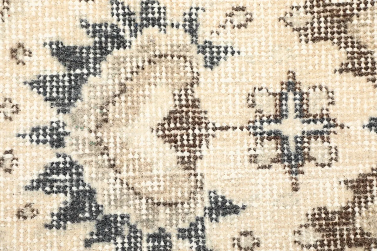 Detailed close-up of the low wool pile, showing vintage wear and color variation