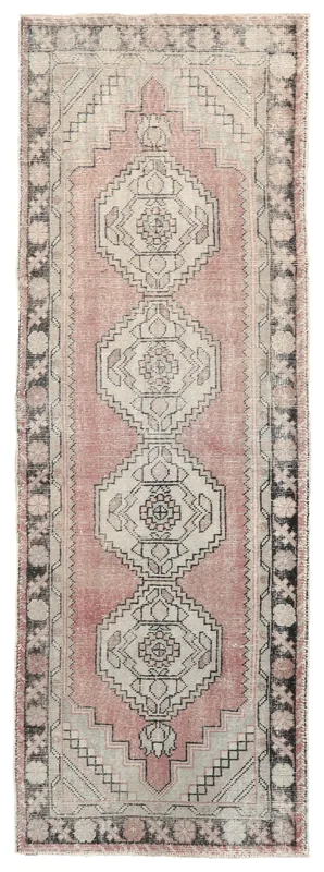 Top view of a rose and gray geometric vintage Anatolian runner rug