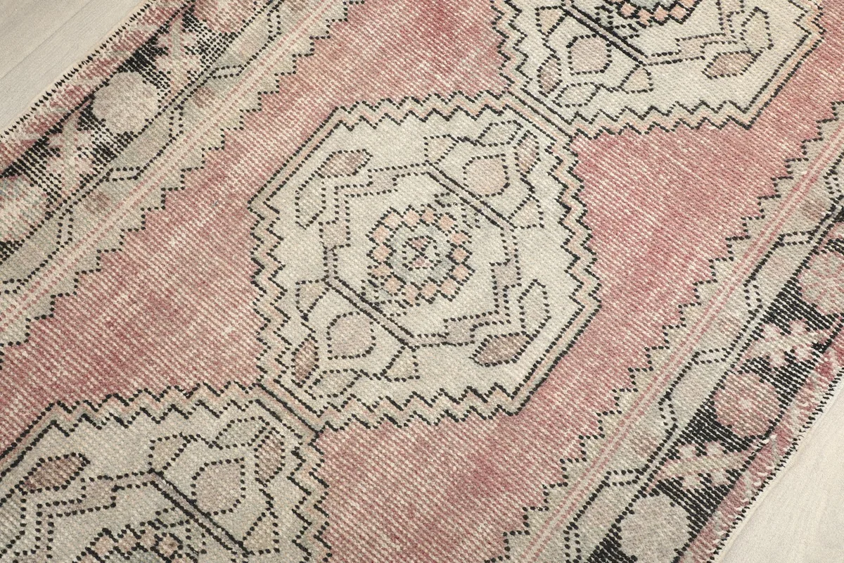 Close-up of a central geometric medallion with intricate gray and ivory details