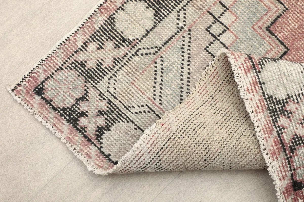 Folded corner showing the wool pile on cotton foundation from the back