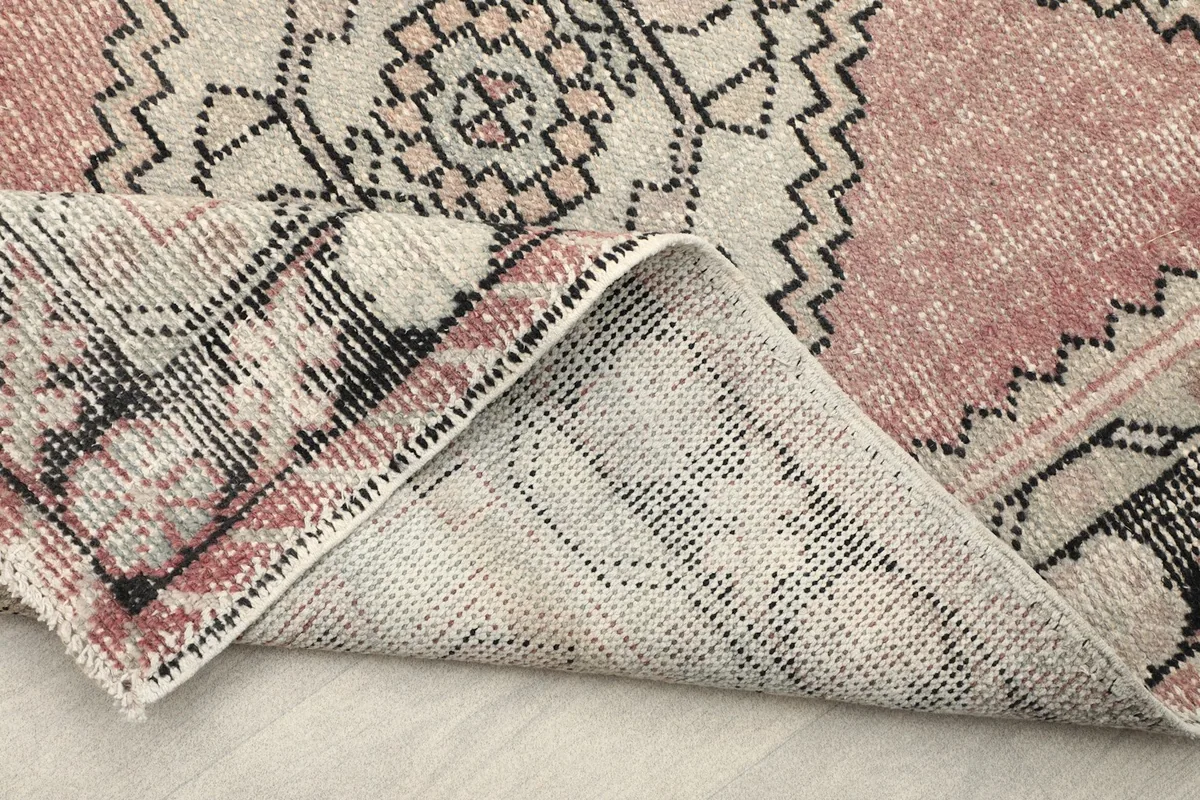 Another folded corner view of the rug's construction and reverse side