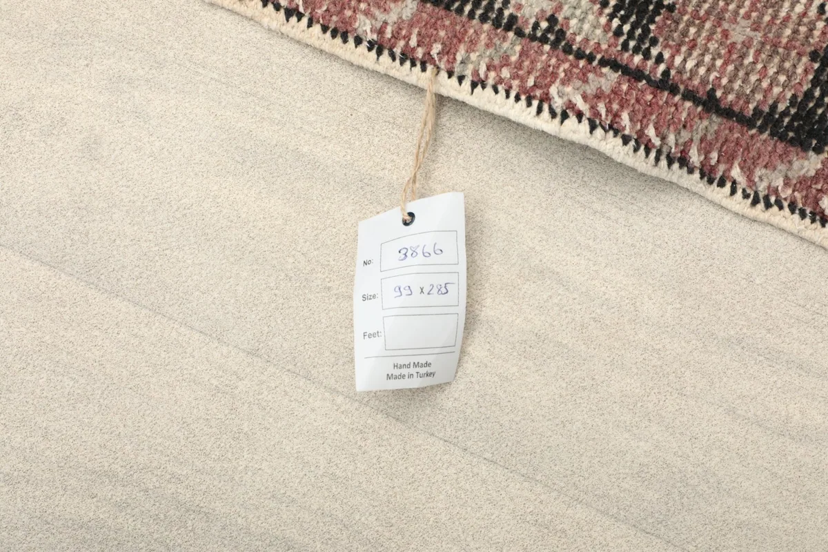 Close-up of the rug's tag displaying dimensions and origin information