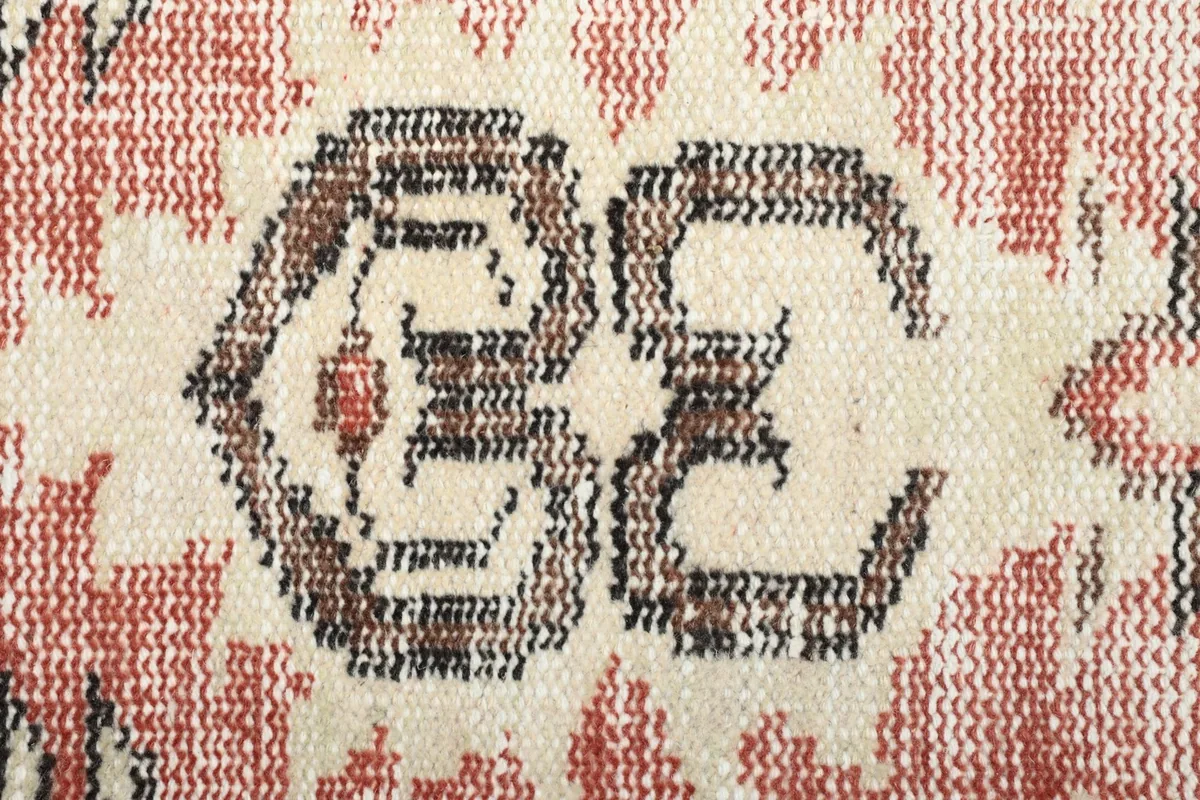 Close-up showing the hand-knotted wool pile texture and color variations of the rug.