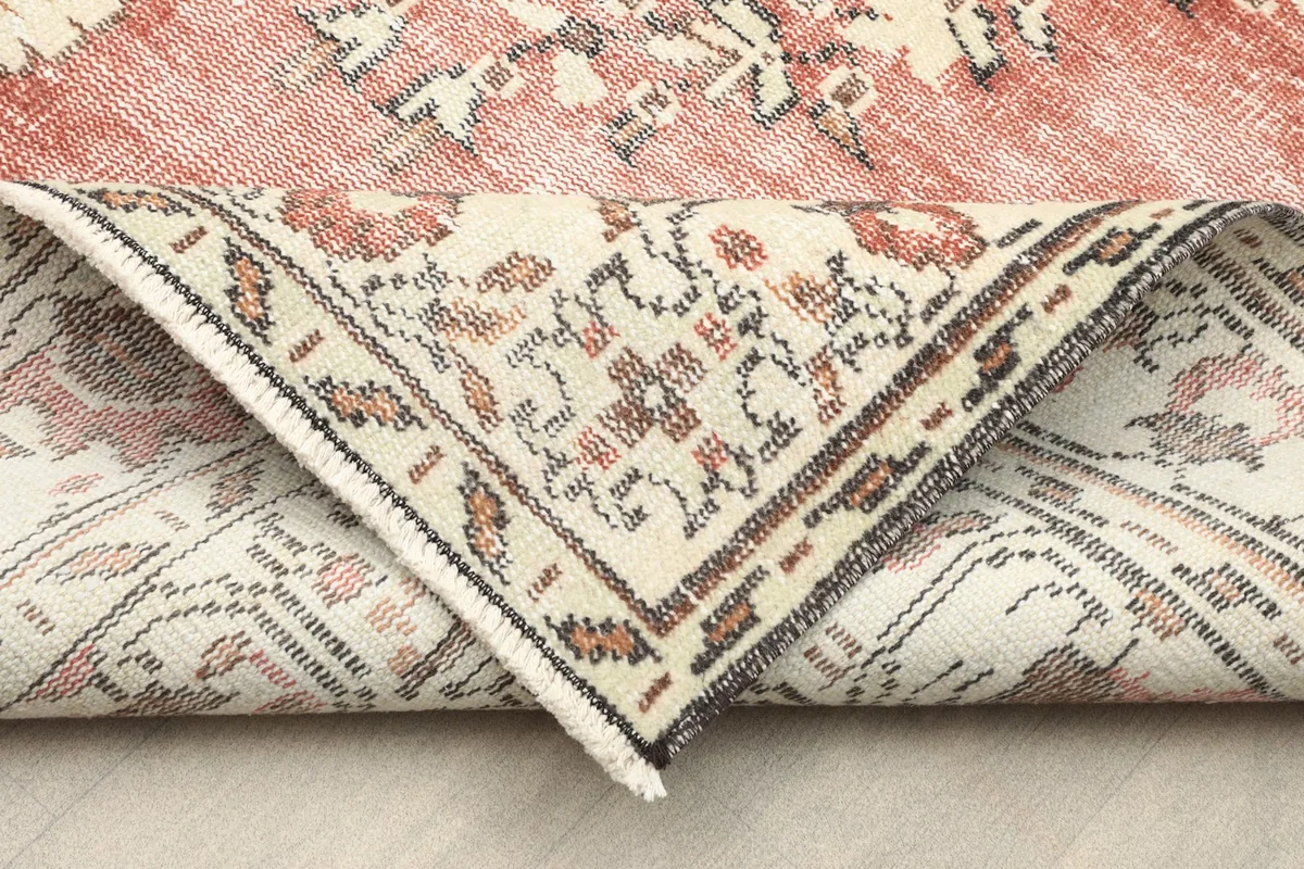 Detail of the rug folded to show the thickness and flexibility of the hand-knotted wool on cotton foundation.